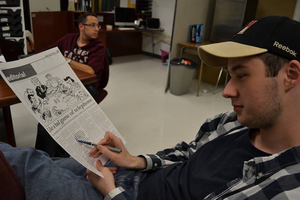 patrick smith editing a page of the Algonquin Times, 2013